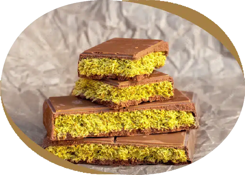 Protein chocolate bars with pistachio filling stacked on paper — Botenz high-protein chocolate treat