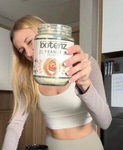 customer holds the peanut butter botenz powder jar